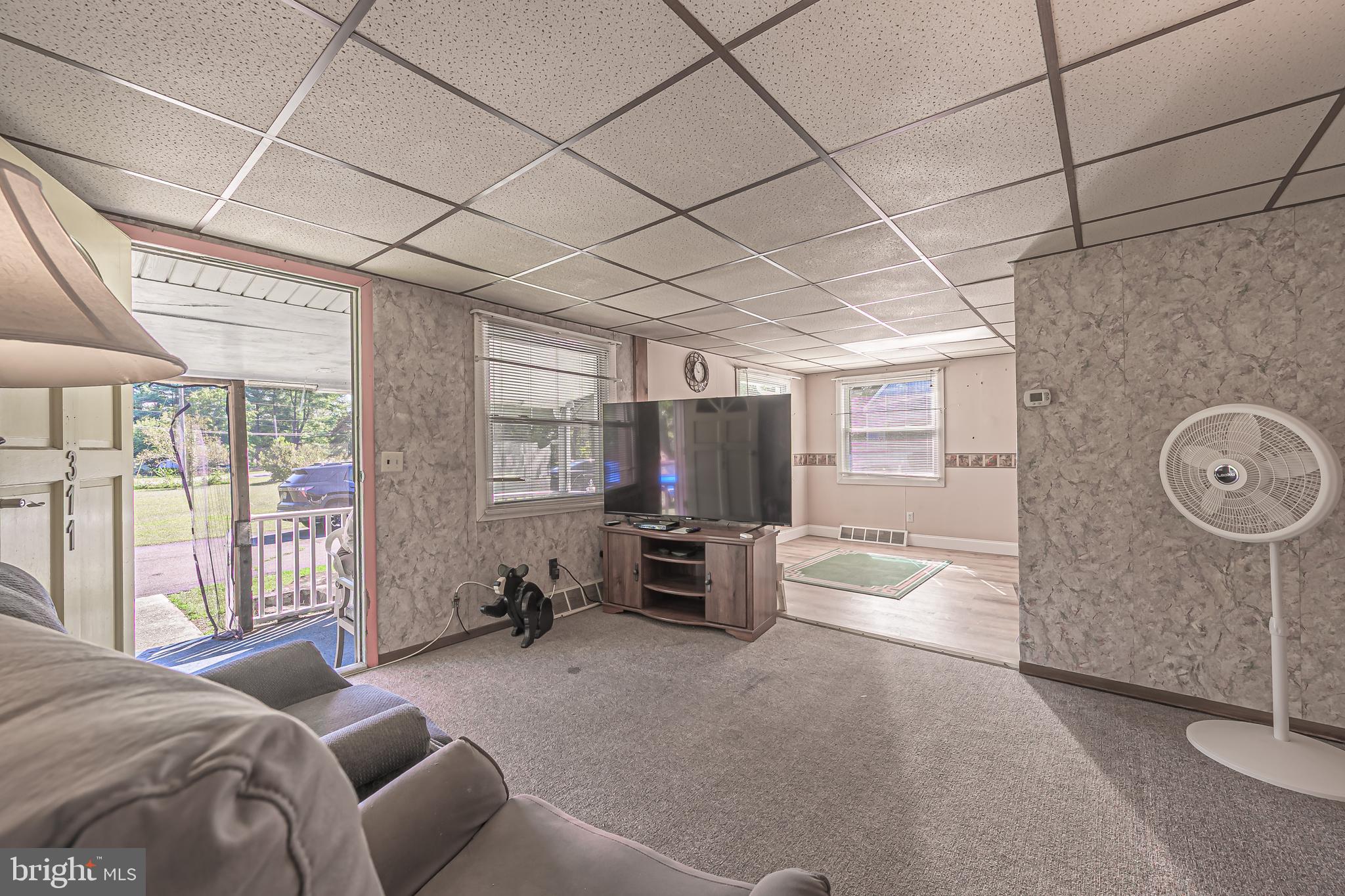 311 Woodruff Carmel Road Bridgeton, NJ 08302 - Photo 10 of 40 a living room with furniture and a flat screen tv