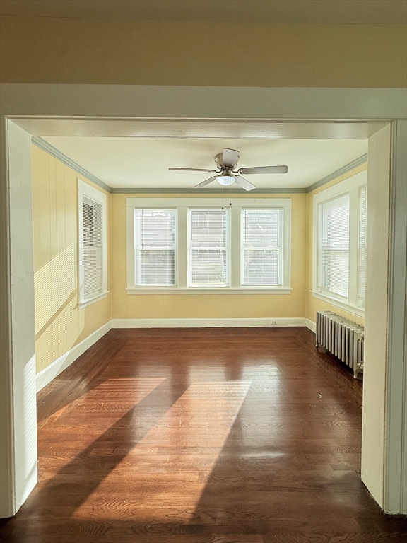 139 Endicott Street Worcester, MA 01610 - Photo 3 of 9 a view of empty room with wooden floor and fan