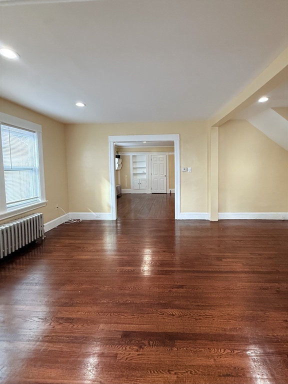139 Endicott Street Worcester, MA 01610 - Photo 4 of 9 an empty room with wooden floor and windows