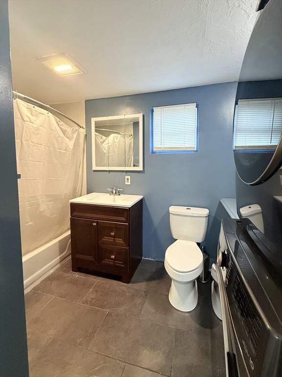 139 Endicott Street Worcester, MA 01610 - Photo 5 of 9 a bathroom with a toilet a sink and mirror