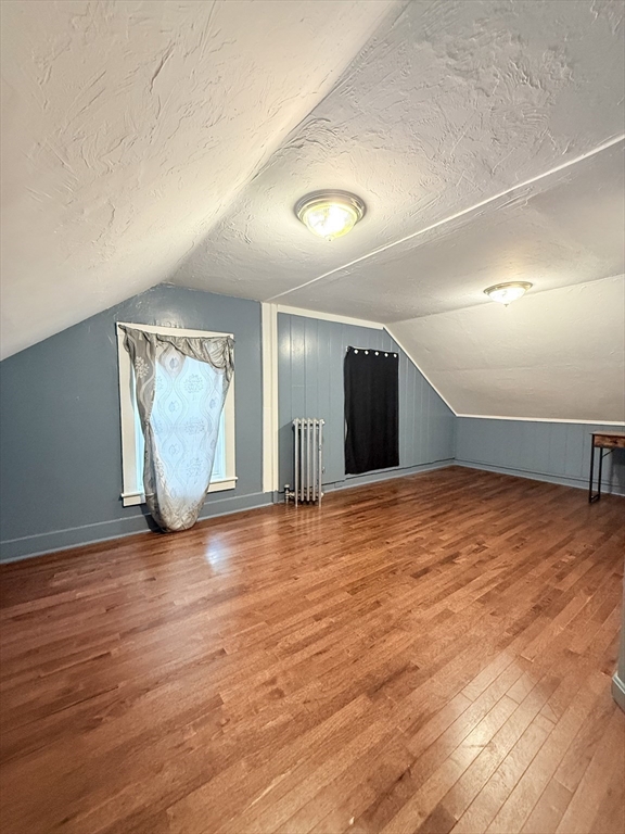 139 Endicott Street Worcester, MA 01610 - Photo 6 of 9 an empty room with wooden floor and windows