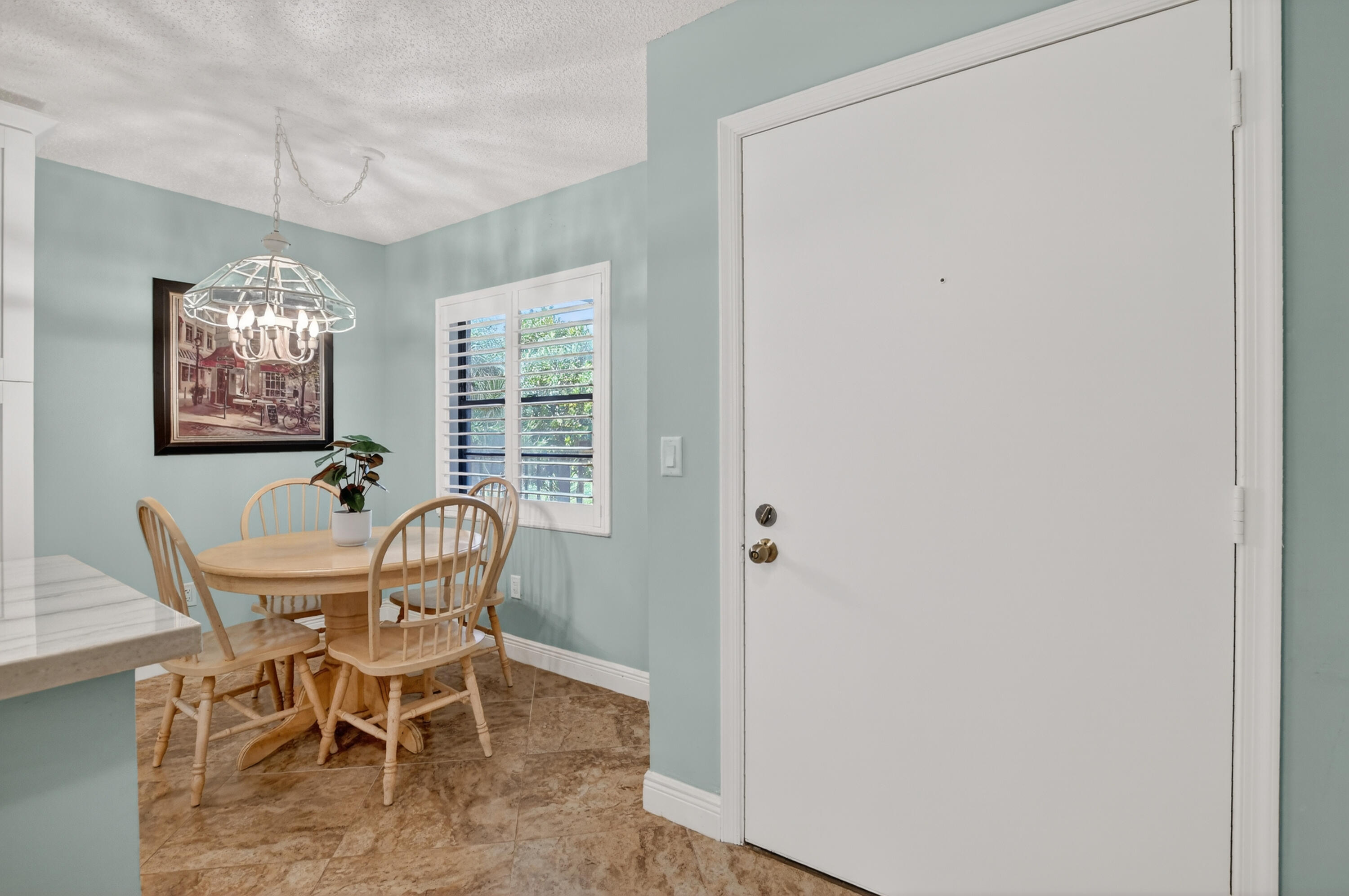 23345 Carolwood Lane, Unit 205 Boca Raton, FL 33428 - Photo 5 of 59 a view of a dining room with furniture and chandelier