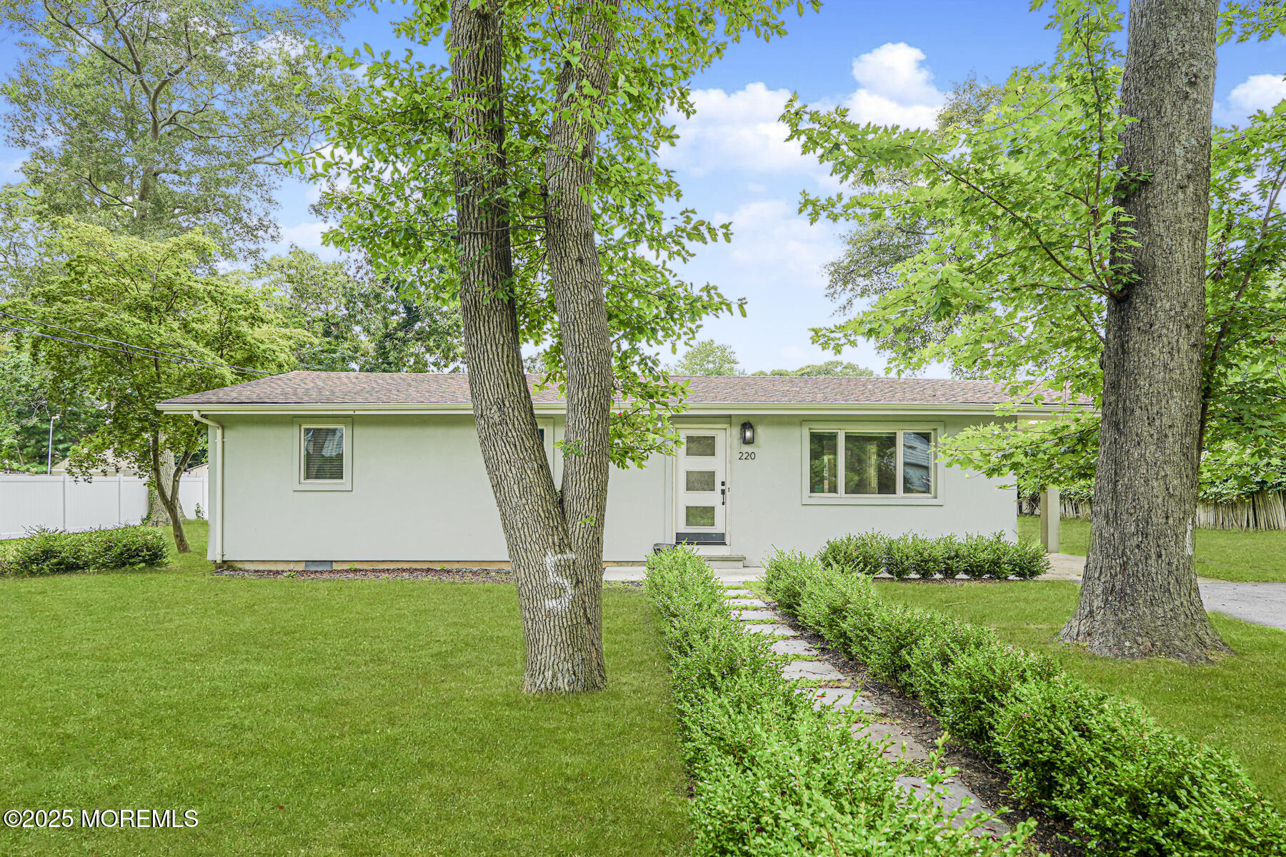 a front view of house with a garden