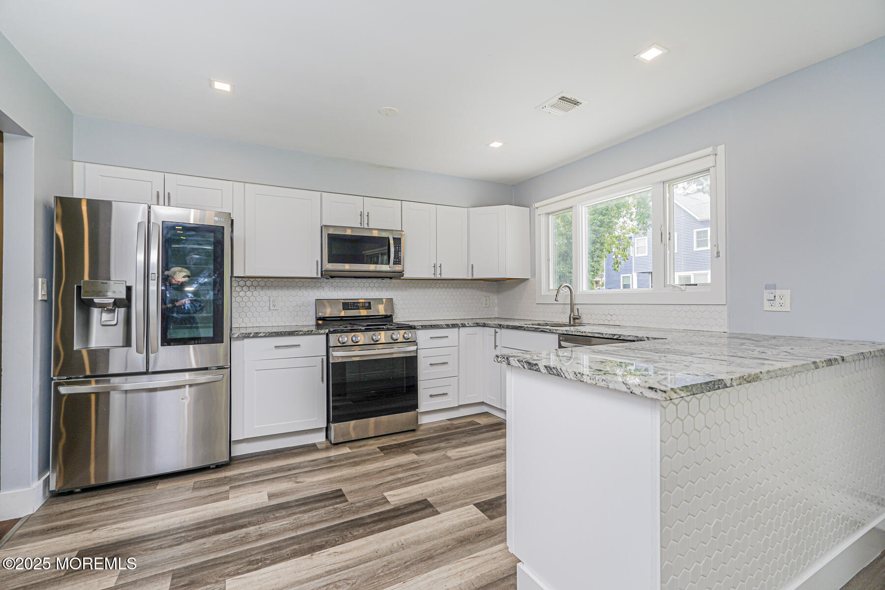 220 Highwood Road Oakhurst, NJ 07755 - Photo 11 of 30 a kitchen with granite countertop a refrigerator stove and microwave