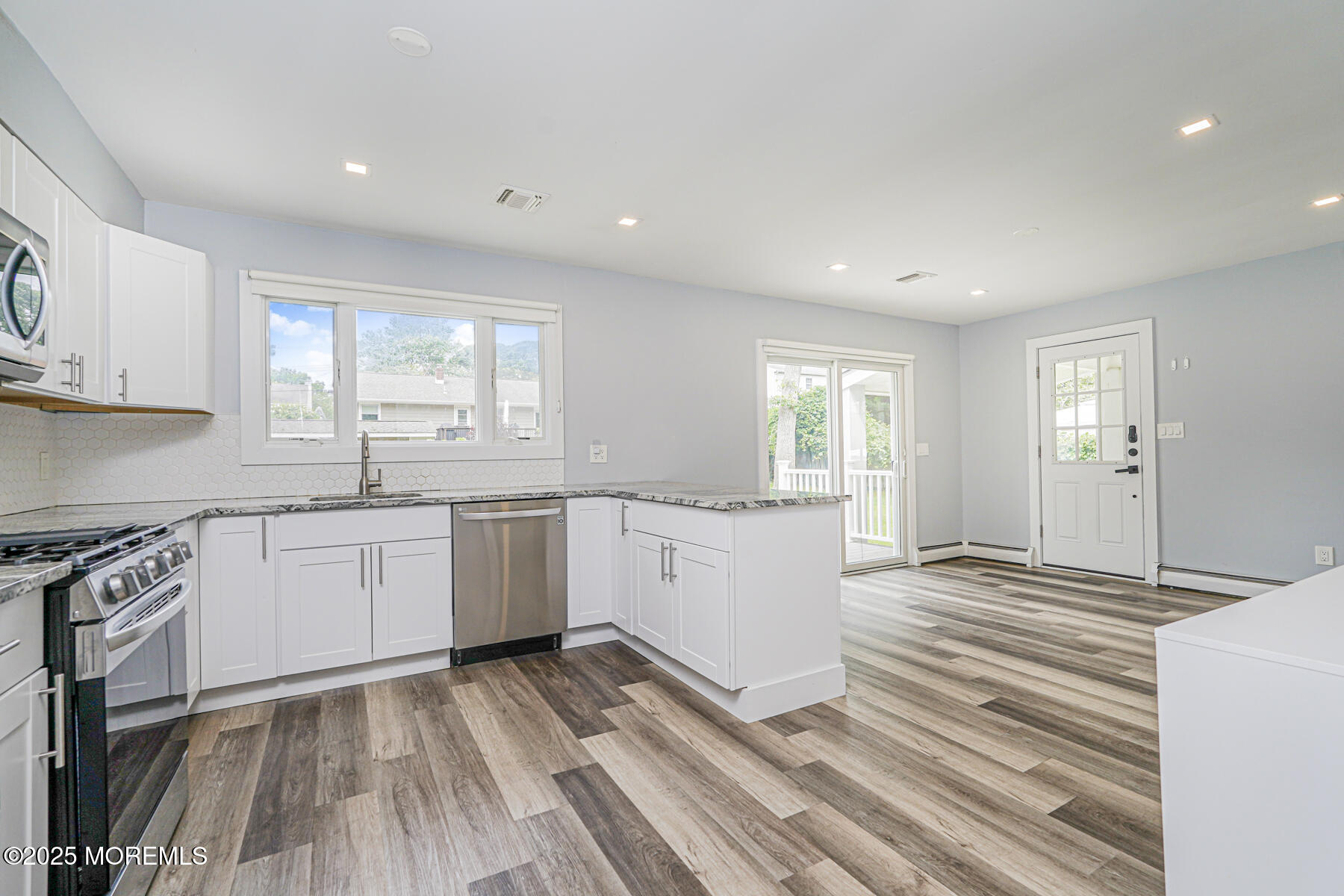 220 Highwood Road Oakhurst, NJ 07755 - Photo 12 of 30 a kitchen with a sink window and cabinets