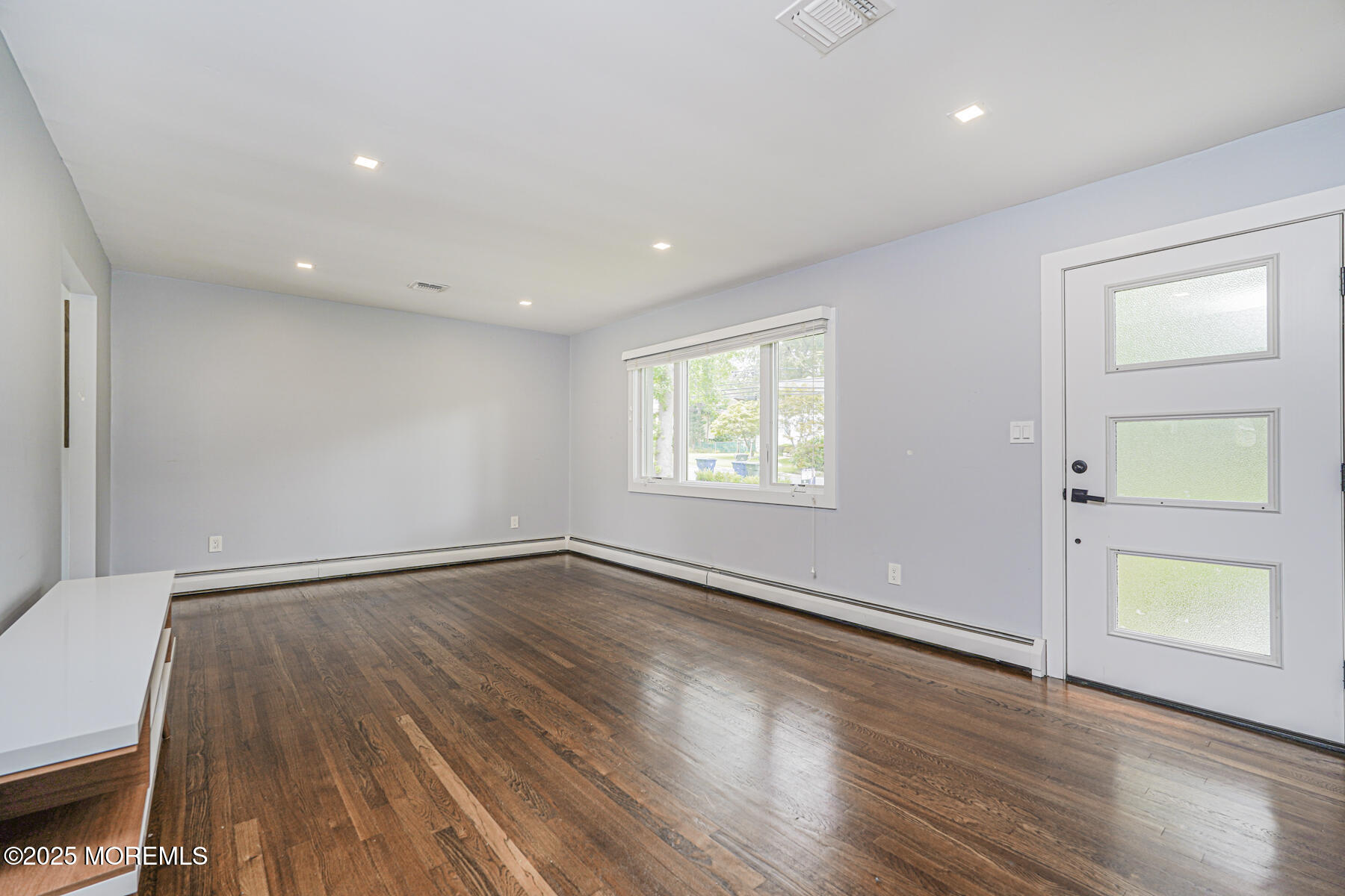220 Highwood Road Oakhurst, NJ 07755 - Photo 14 of 30 an empty room with wooden floor and windows