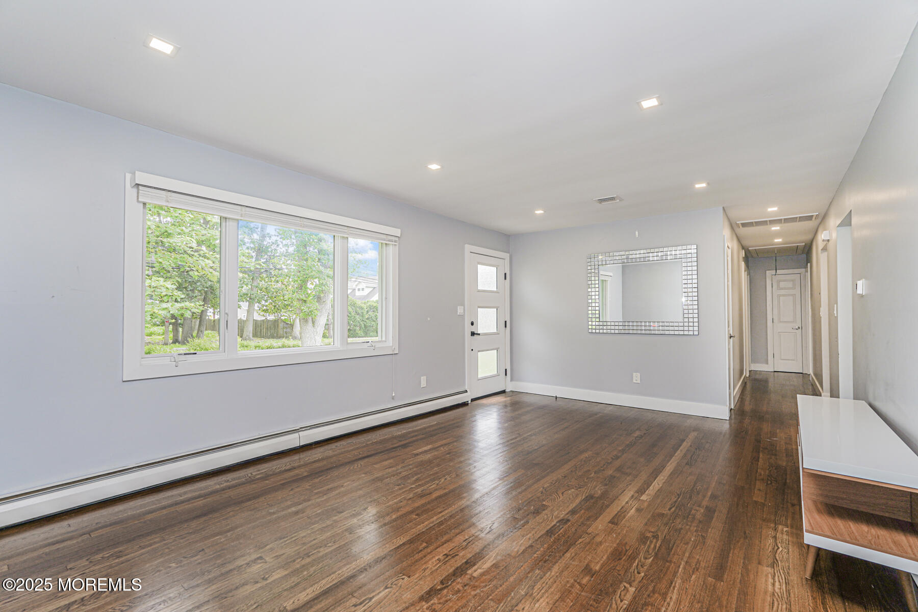 220 Highwood Road Oakhurst, NJ 07755 - Photo 16 of 30 a view of an empty room with wooden floor and a window