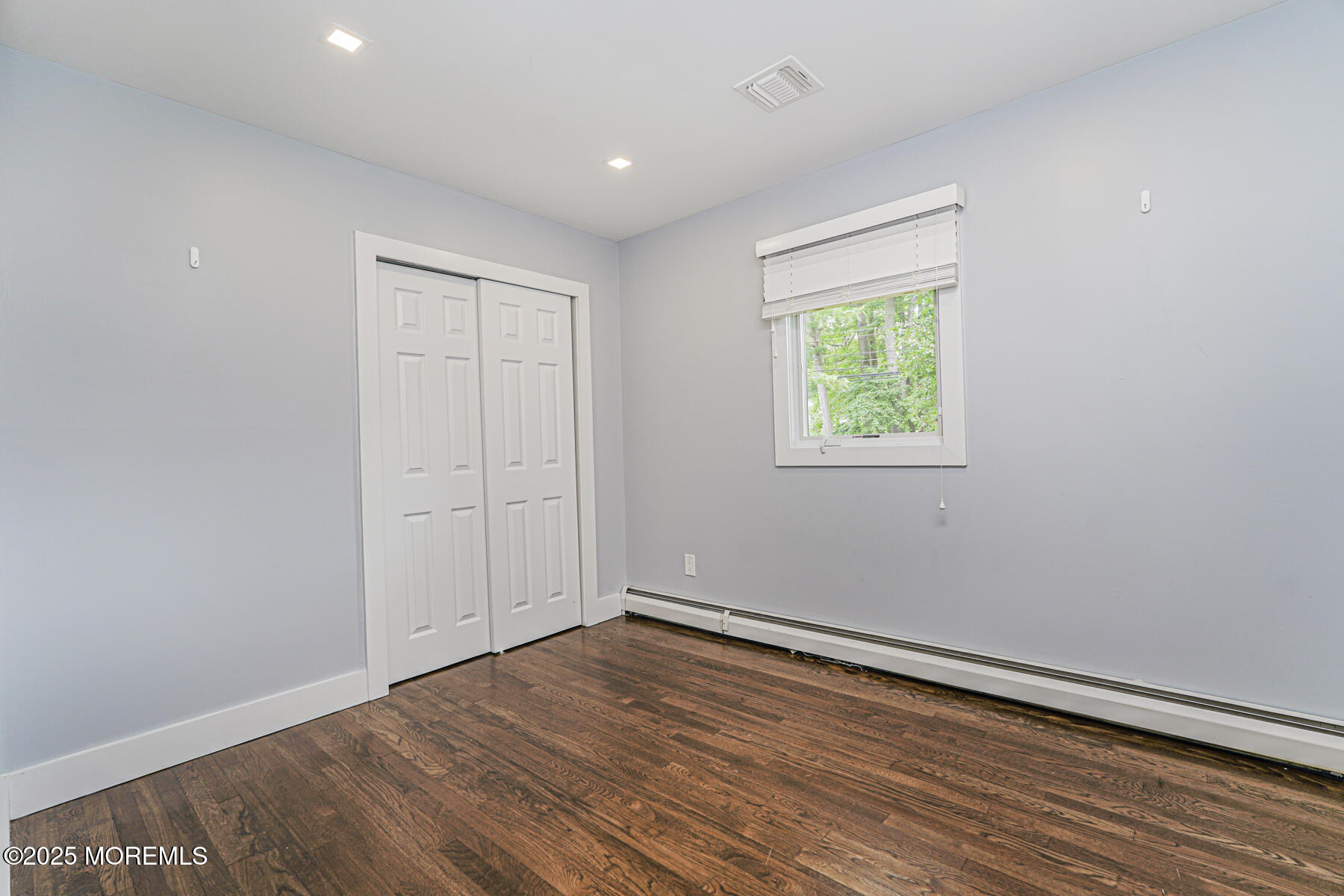 220 Highwood Road Oakhurst, NJ 07755 - Photo 18 of 30 wooden floor in an empty room with window