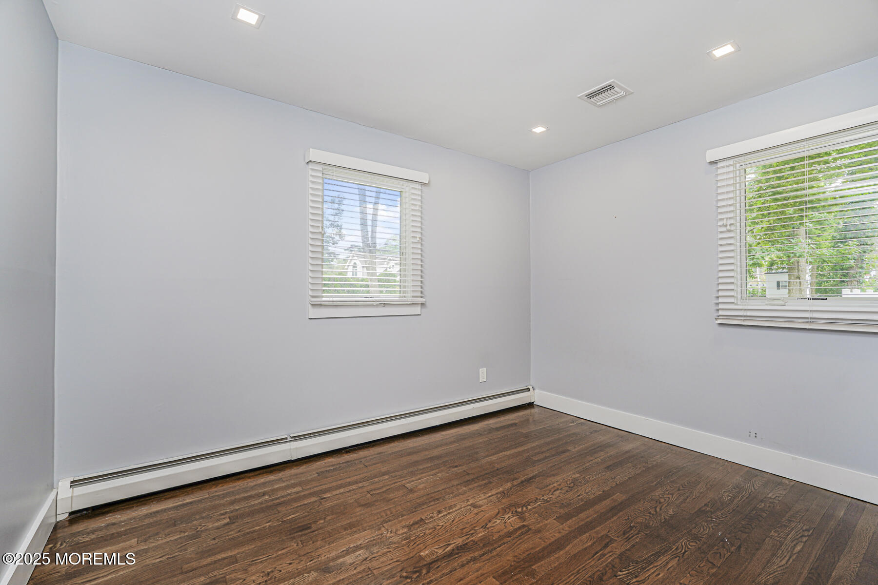 220 Highwood Road Oakhurst, NJ 07755 - Photo 19 of 30 an empty room with wooden floor and windows