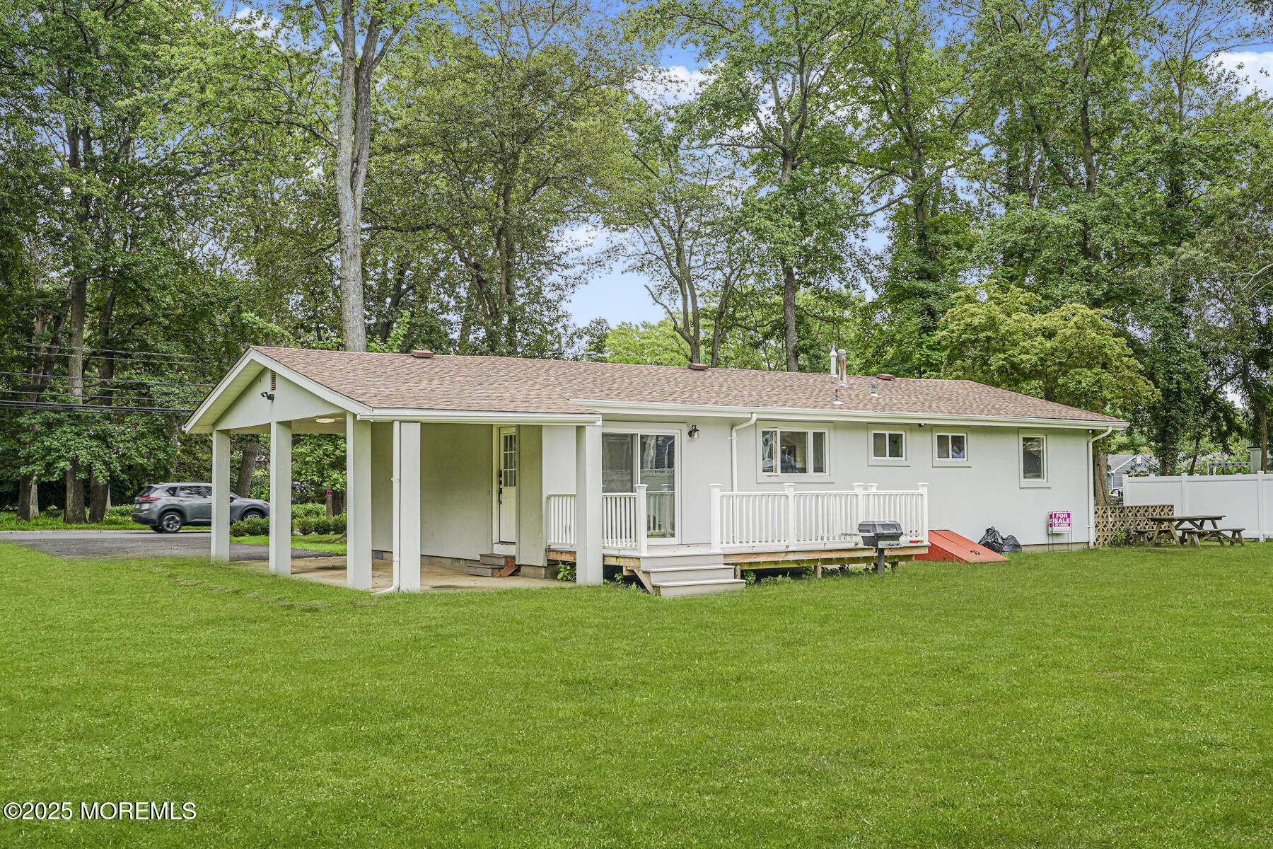 220 Highwood Road Oakhurst, NJ 07755 - Photo 26 of 30 a front view of a house with a garden and trees