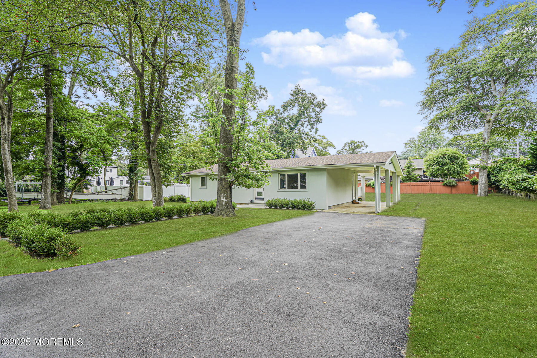 220 Highwood Road Oakhurst, NJ 07755 - Photo 4 of 30 a front view of a house with a yard and garage