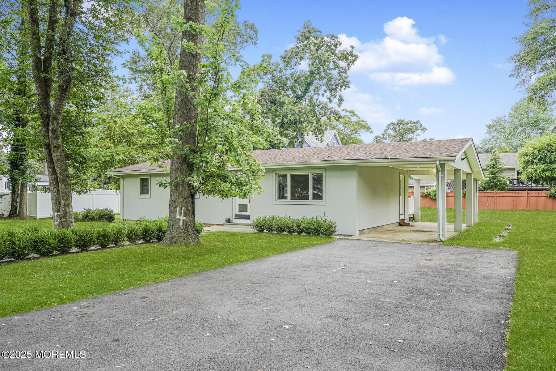 220 Highwood Road Oakhurst, NJ 07755 - Photo 5 of 30 a front view of a house with a yard and trees