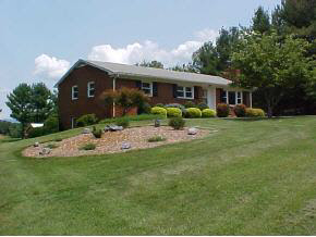 148 Baynes Road Waynesboro, VA 22980 - Photo 1 of 4 a front view of a house with a garden and porch