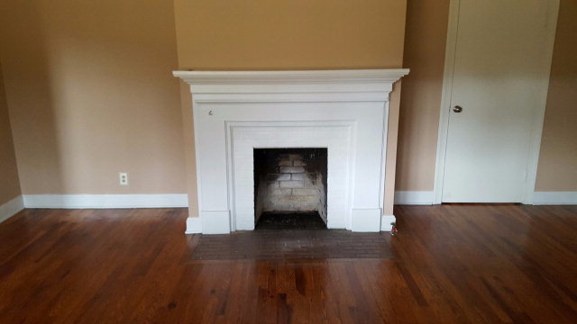 6085 Forsyth Road Macon, GA 31210 - Photo 14 of 15 a view of an empty room with wooden floor and a fireplace