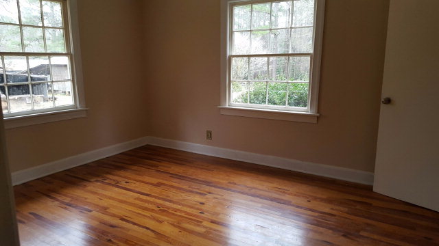 6085 Forsyth Road Macon, GA 31210 - Photo 8 of 15 an empty room with wooden floor and windows