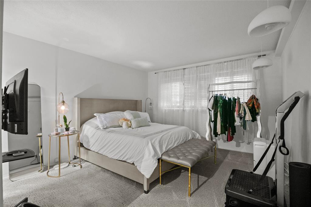 2141 Northeast 68th Street, Unit 107 Fort Lauderdale, FL 33308 - Photo 12 of 20 a bedroom with a bed and a walk in closet