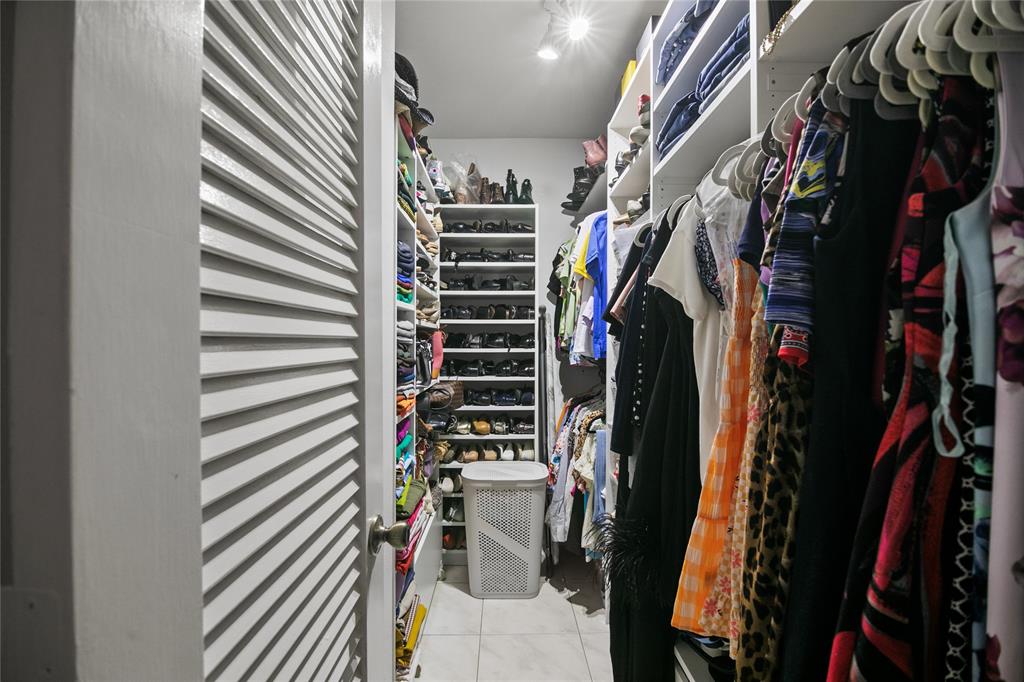 2141 Northeast 68th Street, Unit 107 Fort Lauderdale, FL 33308 - Photo 13 of 20 a view of walk in closet with clothes and shoes
