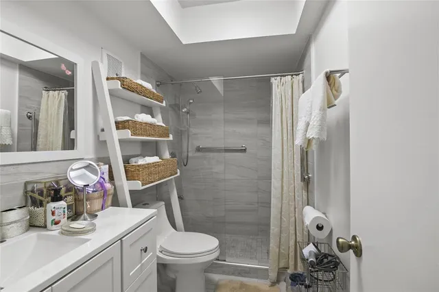 a bathroom with a sink toilet and shower
