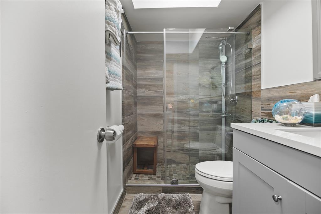 2141 Northeast 68th Street, Unit 107 Fort Lauderdale, FL 33308 - Photo 15 of 20 a bathroom with a shower and a toilet