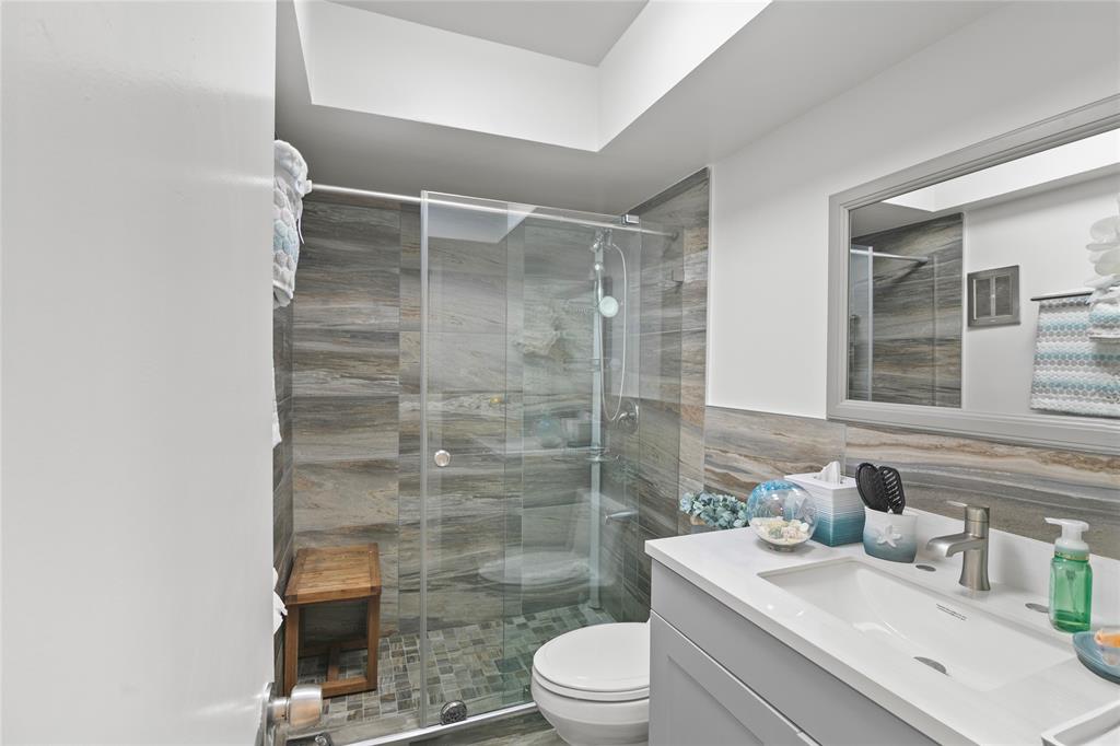 2141 Northeast 68th Street, Unit 107 Fort Lauderdale, FL 33308 - Photo 16 of 20 a bathroom with a sink a toilet and shower