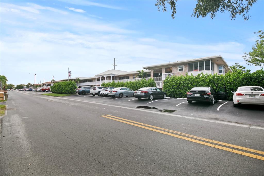2141 Northeast 68th Street, Unit 107 Fort Lauderdale, FL 33308 - Photo 20 of 20 a car parked on the side of the road