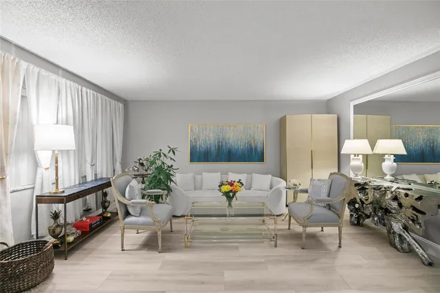 a living room with furniture and a potted plant