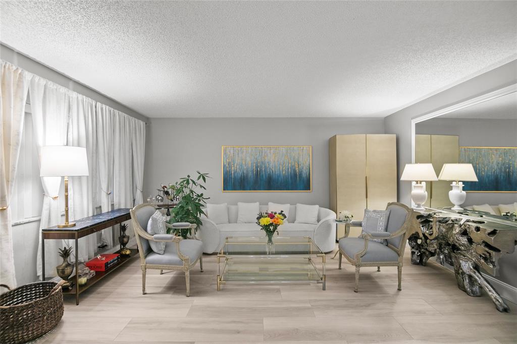 2141 Northeast 68th Street, Unit 107 Fort Lauderdale, FL 33308 - Photo 4 of 20 a living room with furniture and a potted plant