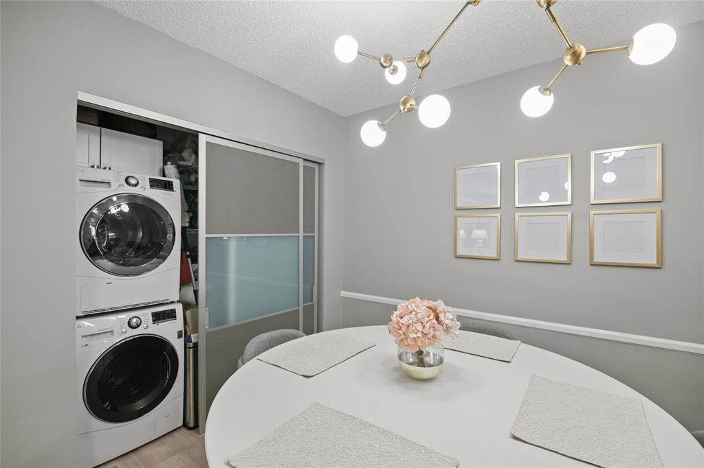 2141 Northeast 68th Street, Unit 107 Fort Lauderdale, FL 33308 - Photo 9 of 20 a bedroom with a bed and a washing machine