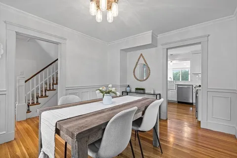 a view of a dining room with furniture and a chandelier