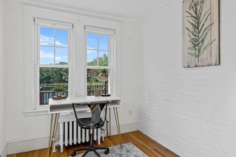 a view of a room with a table and chairs