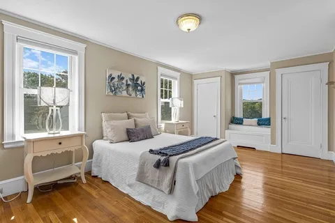 a bedroom with a large bed and a window