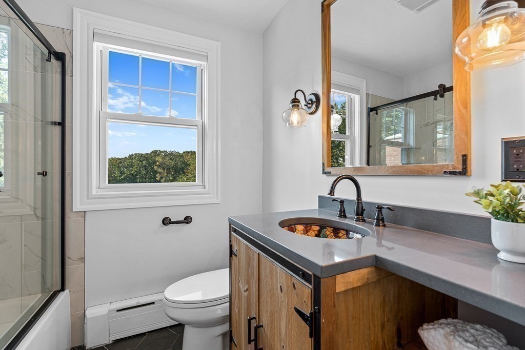 32 Woodside Road Winchester, MA 01890 - Photo 28 of 42 a bathroom with a toilet a sink and a mirror