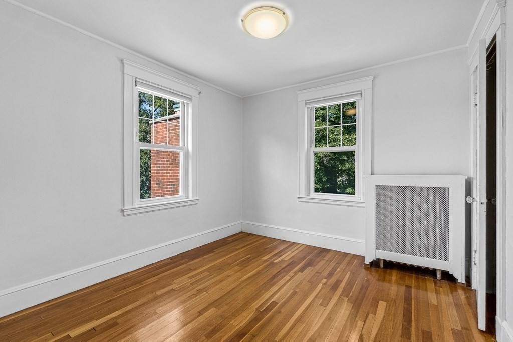 32 Woodside Road Winchester, MA 01890 - Photo 31 of 42 a view of an empty room with wooden floor and a window