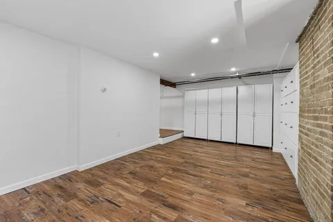 a big room with wooden floor and windows