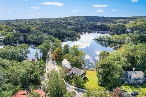 an aerial view of a house with a yard basket ball court and outdoor seating
