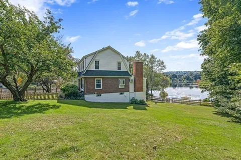 a view of a house with a wooden fence