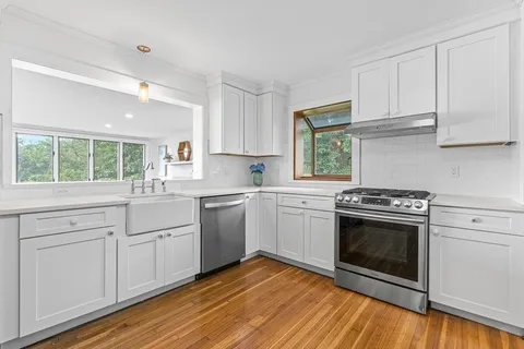 a kitchen with a stove oven and sink