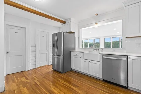 a kitchen with a refrigerator and a sink