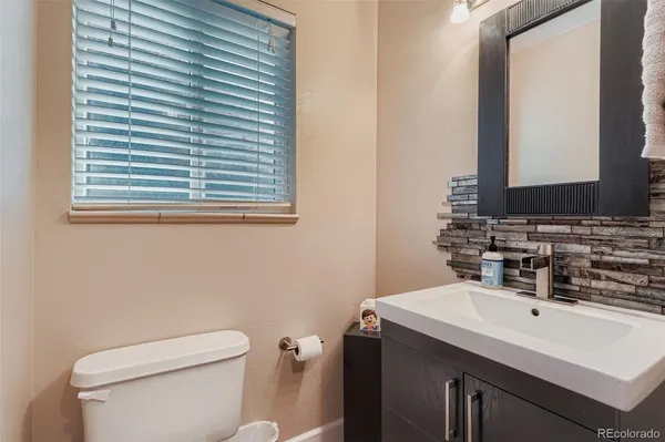 a bathroom with a sink a toilet and mirror