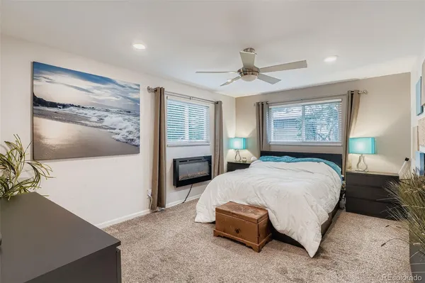 a spacious bedroom with a bed and a flat screen tv