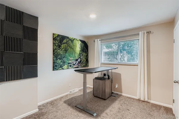 a view of workspace with furniture and window