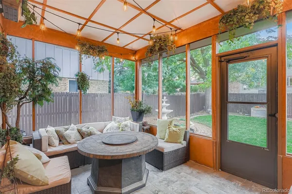 a outdoor space with the couches and dining table with the garden view