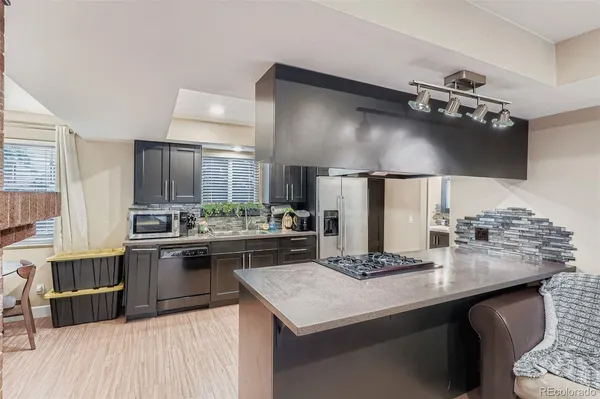a kitchen with kitchen island a sink stove and refrigerator