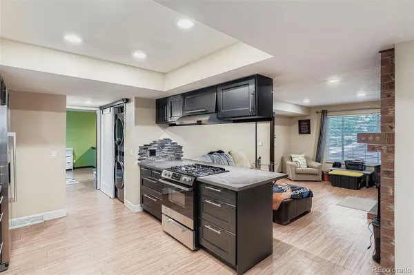 a kitchen with stainless steel appliances kitchen island granite countertop a stove and a sink