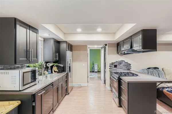 a kitchen that has a lot of cabinets in it and appliances