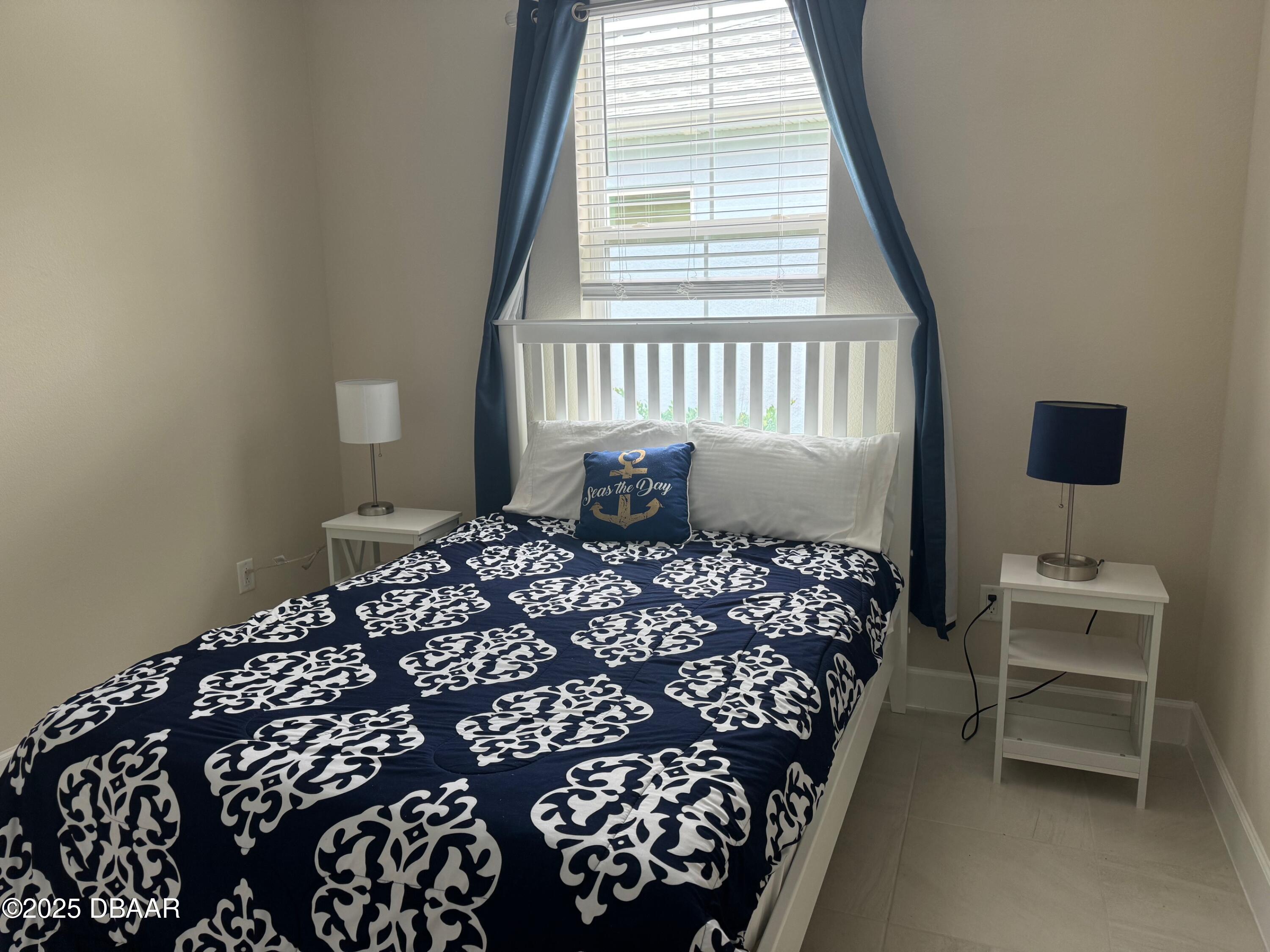 1016 Sea Shell Court Daytona Beach, FL 32124 - Photo 11 of 25 a bedroom with a bed and a window