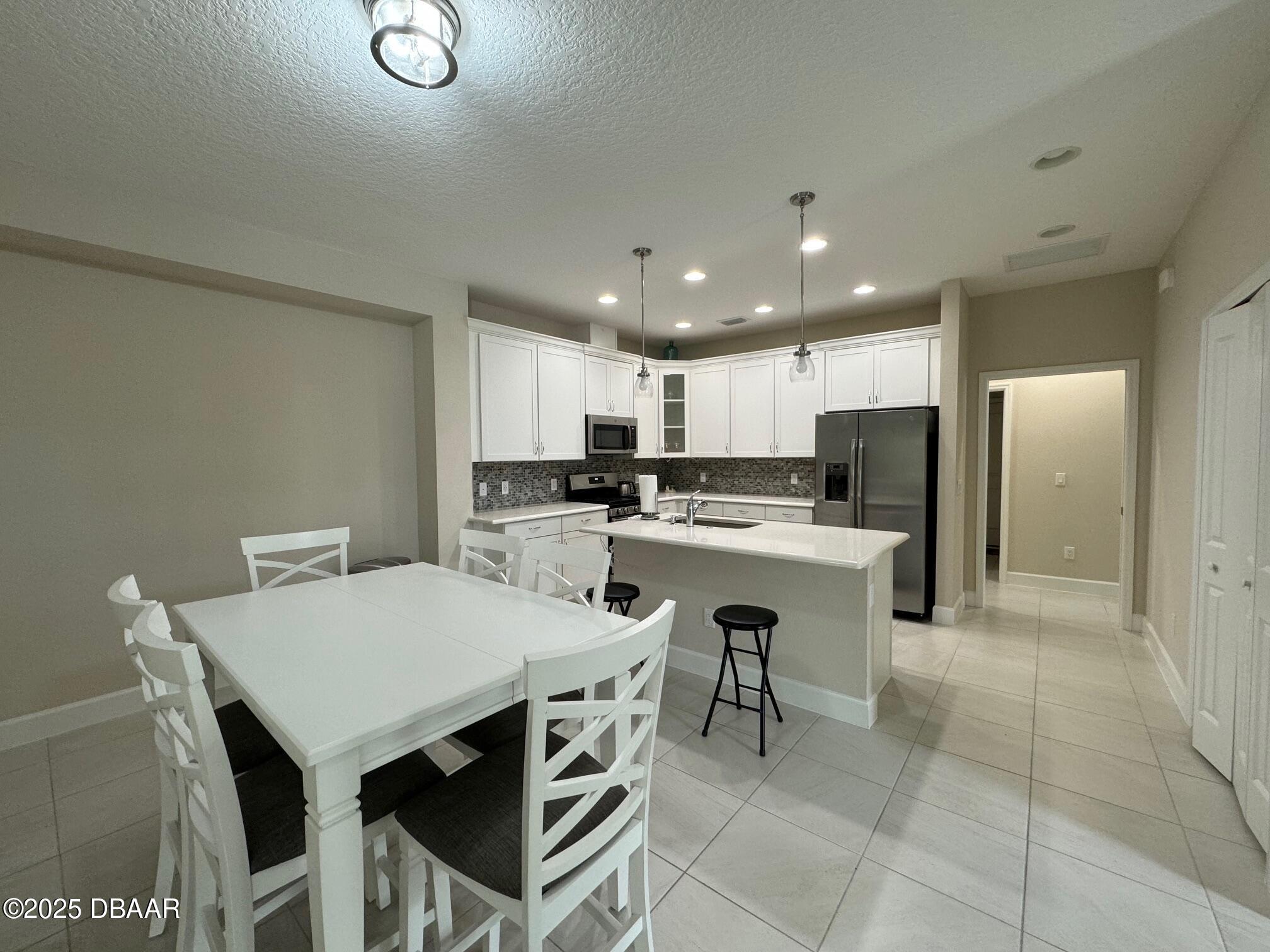 1016 Sea Shell Court Daytona Beach, FL 32124 - Photo 18 of 25 a kitchen with a table and chairs in it
