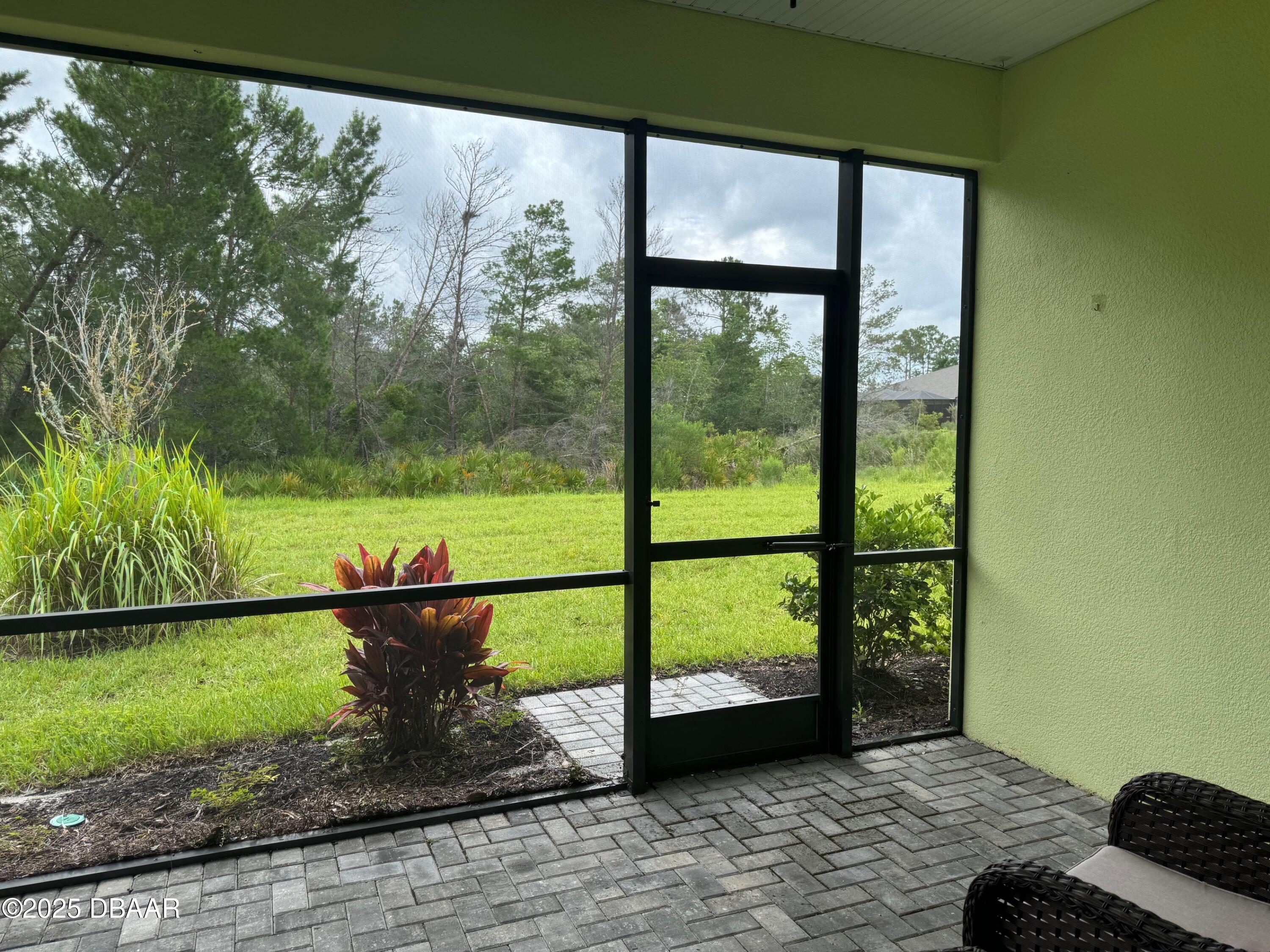1016 Sea Shell Court Daytona Beach, FL 32124 - Photo 23 of 25 a view of a room with a floor to ceiling window and a yard