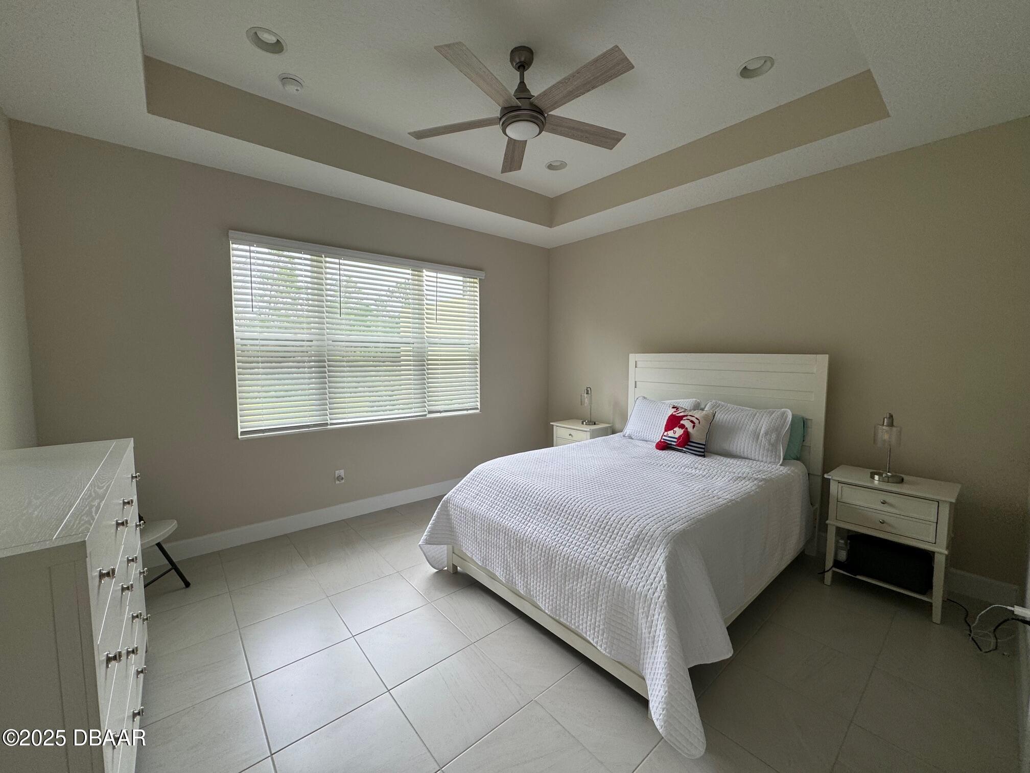 1016 Sea Shell Court Daytona Beach, FL 32124 - Photo 4 of 25 a bedroom with a bed and a ceiling fan