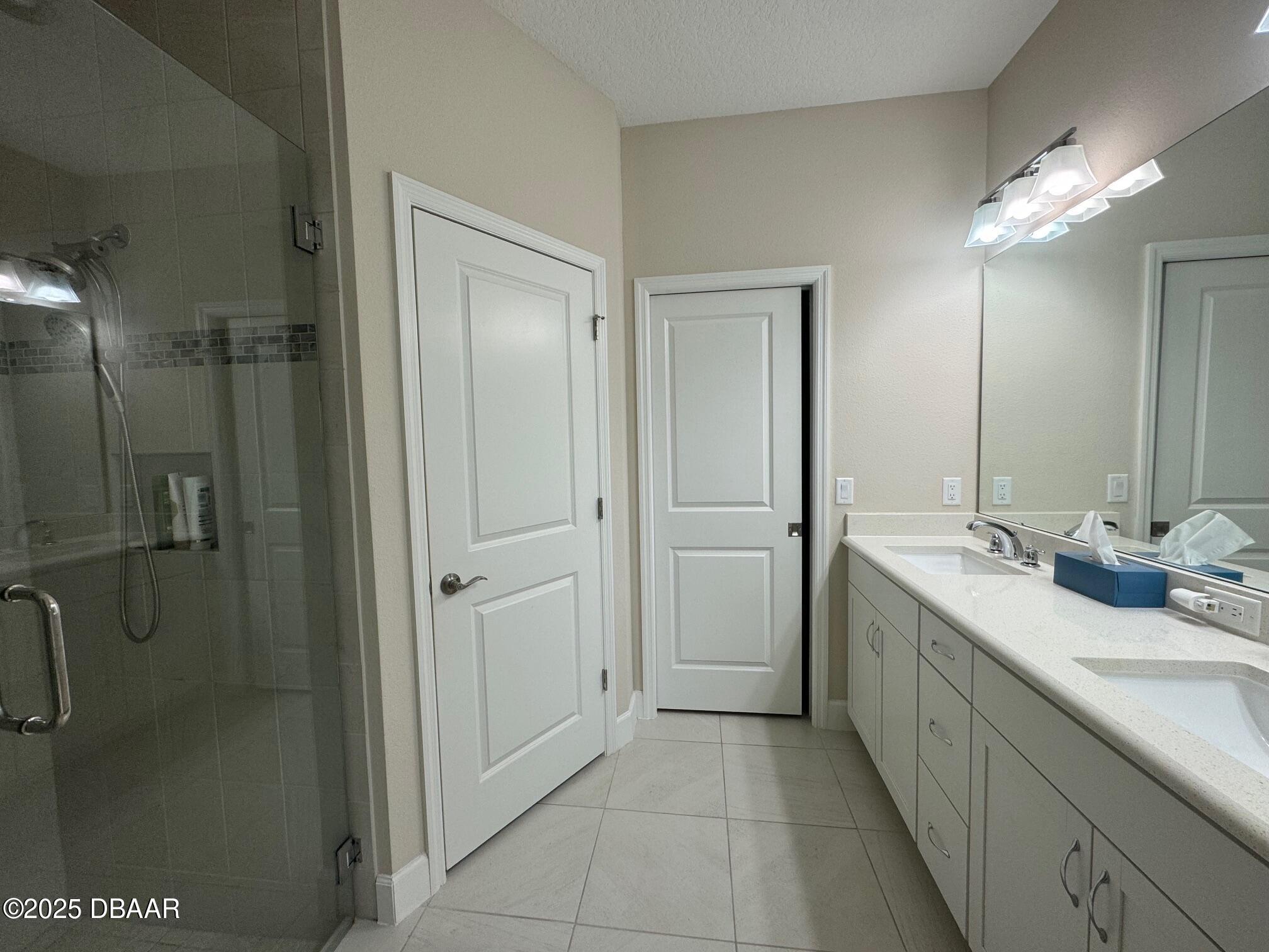 1016 Sea Shell Court Daytona Beach, FL 32124 - Photo 7 of 25 a bathroom with a double vanity sink mirror and shower